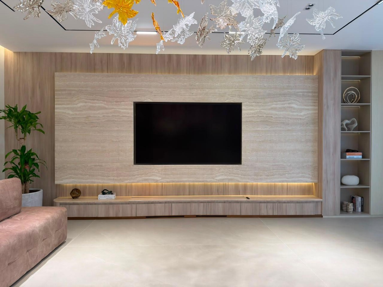 Family living room with travertine TV wall, marble-clad columns and coffered ceiling