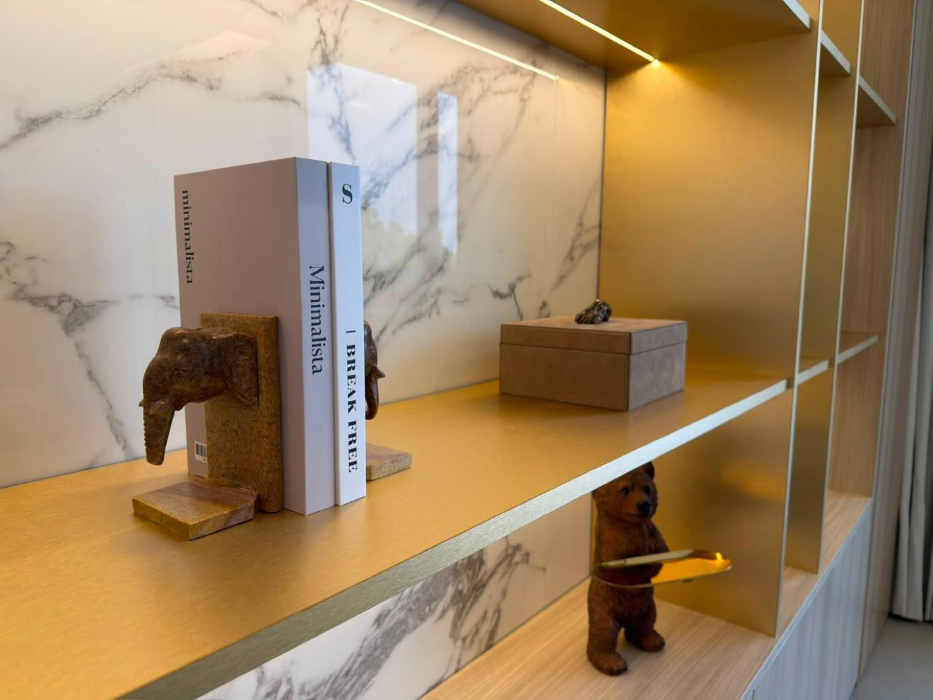 Detail of styled display shelves with books and ceramic vases
