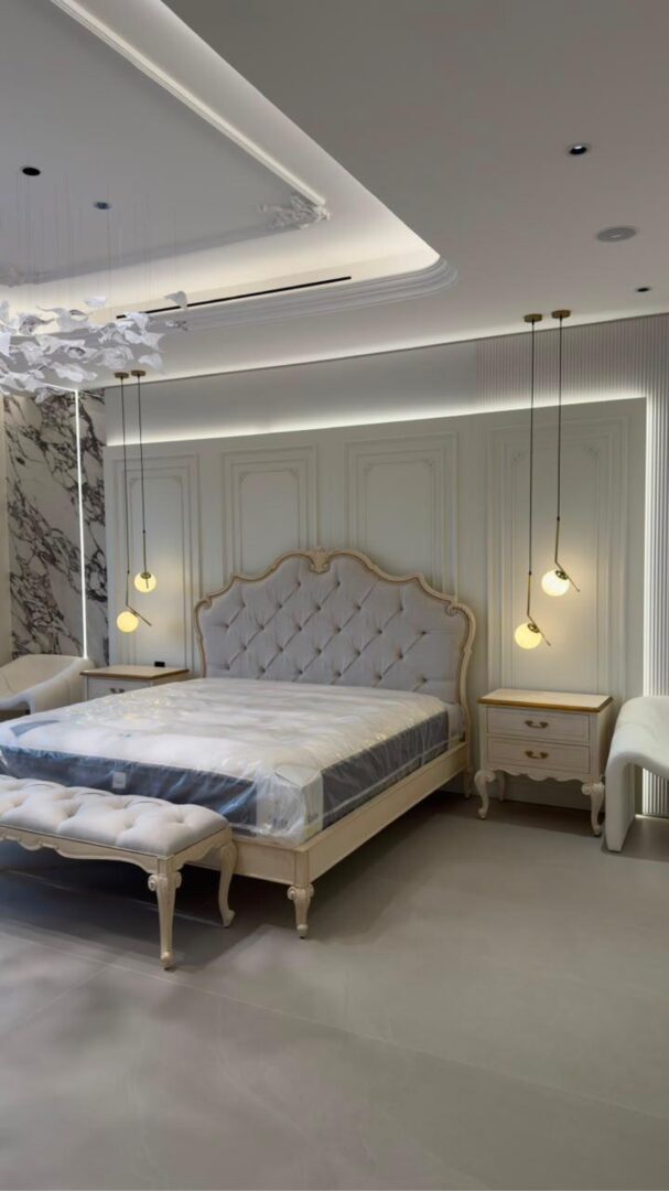 Master bedroom with marble feature wall, mirrored panels and crystal chandelier